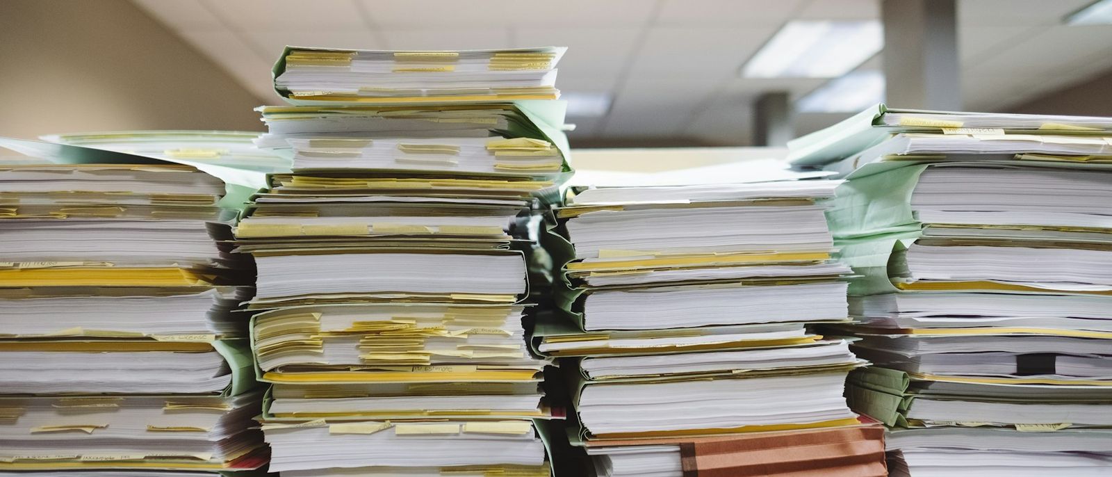 Stacked paper documents and file folders
